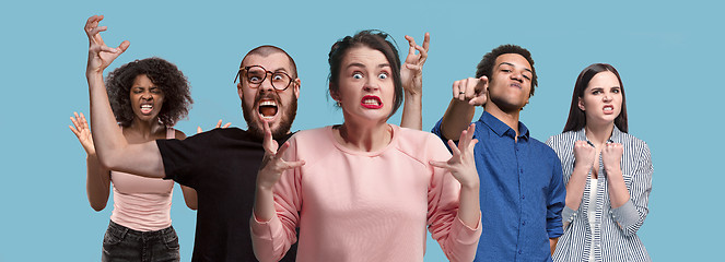 Image showing The young emotional angry and scared men and women standing and looking at camera