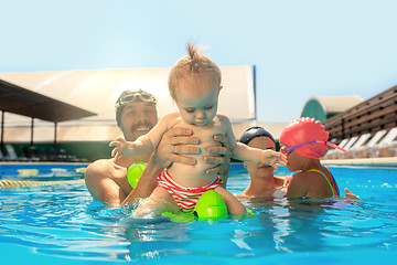 Image showing Happy family having fun by the swimming pool