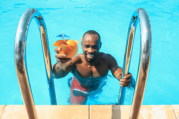 Image showing The portrait of happy smiling beautiful man at the pool