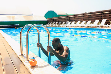 Image showing The portrait of happy smiling beautiful man at the pool