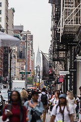 Image showing New York, NY, USA - May 17, 2018: Crowds of people walking sidewalk of Broadway avenue in Soho of Midtown Manhattan on may 17th, 2018 in New York City, USA.