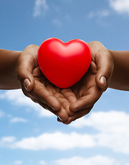 Image showing female hands with small red heart