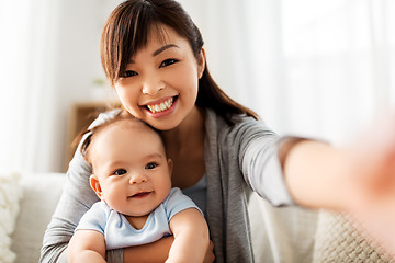 Image showing happy mother with little baby son taking selfie