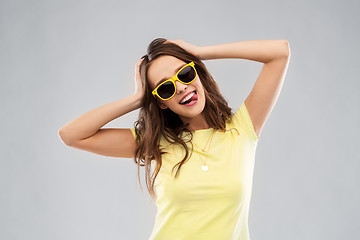 Image showing teenage girl in yellow sunglasses and t-shirt