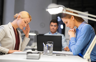 Image showing business team with laptop working late at office