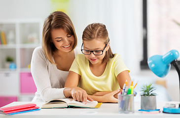 Image showing mother and daughter doing homework together