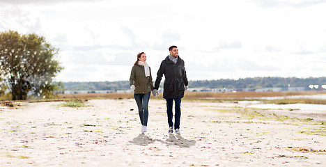 Image showing couple walking along autumn beach