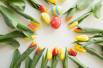 Image showing close up of colored easter eggs and tulip flowers