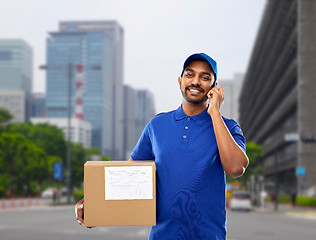 Image showing indian delivery man with smartphone and parcel box