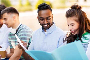 Image showing international students with notebooks outdoors