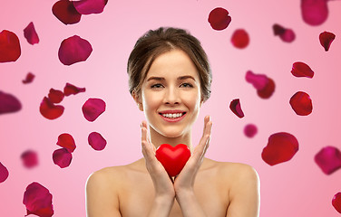 Image showing beautiful smiling woman holding red heart