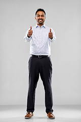 Image showing smiling indian businessman showing thumbs up