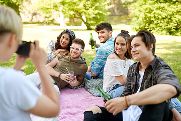 Image showing friends with drinks photographing at summer picnic