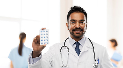 Image showing indian male doctor with pills and stethoscope