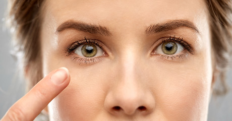 Image showing close up of woman pointin finger to eye