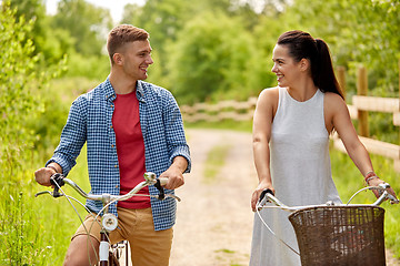 Image showing happy couple with bicycles at summer park