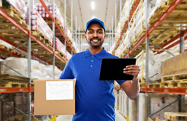 Image showing delivery man with tablet pc and box at warehouse