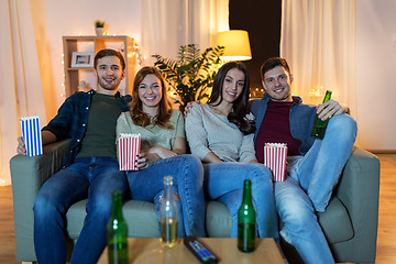 Image showing friends with beer and popcorn watching tv at home