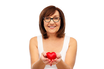 Image showing portrait of smiling senior woman holding red heart