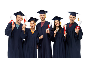 Image showing graduates in mortar boards with diplomas