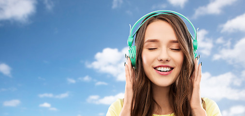 Image showing happy young woman or teenage girl with headphones