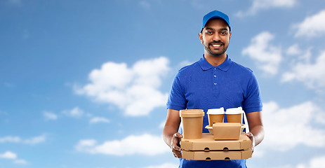 Image showing happy indian delivery man with food and drinks