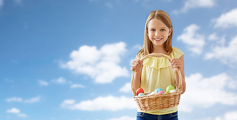 Image showing happy girl with colored eggs in wicker basket