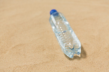 Image showing bottle of water on beach sand