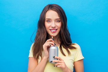 Image showing young woman or teenage girl drinking soda from can