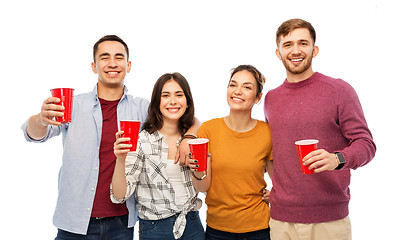 Image showing group of smiling friends with drinks in party cups