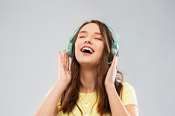 Image showing happy young woman or teenage girl with headphones