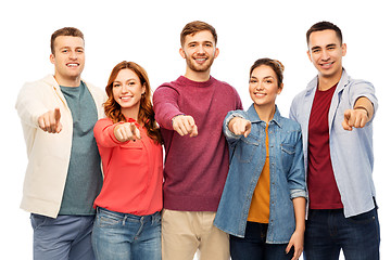 Image showing group of smiling friends pointing at you over