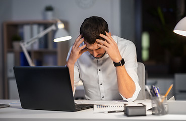 Image showing businessman with papers working at night office