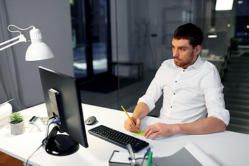 Image showing businessman with computer working at night office