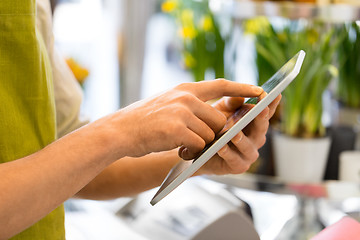 Image showing seller with tablet computer at flower shop