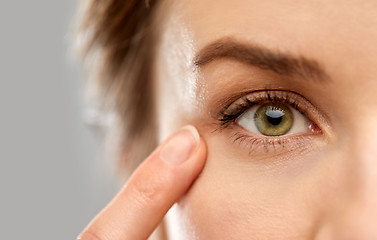 Image showing close up of woman pointin finger to eye