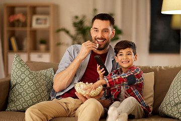 Image showing happy father and son watching tv at home