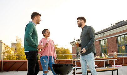 Image showing happy friends having bbq party on rooftop