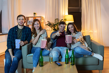 Image showing friends with beer and popcorn watching tv at home