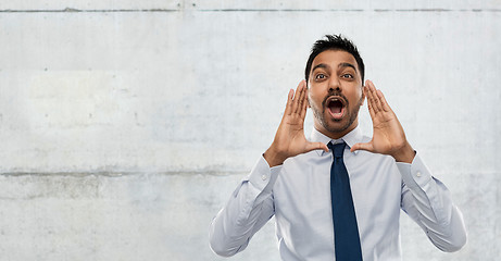 Image showing indian businessman calling someone over concrete