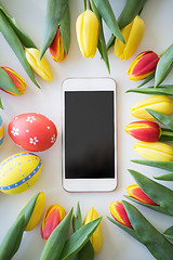 Image showing smartphone with easter eggs and tulip flowers