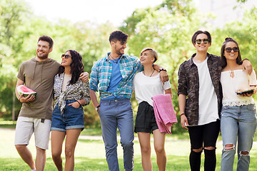 Image showing happy friends with picnic blanket at summer park