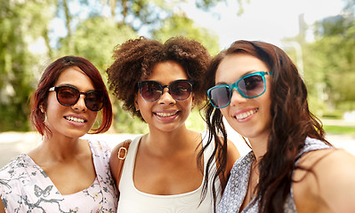 Image showing happy young women in sunglasses at summer park