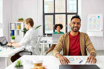 Image showing indian male creative worker with laptop at office