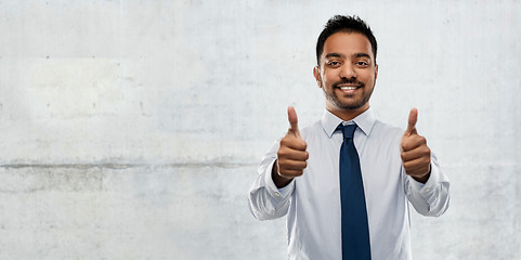 Image showing indian businessman showing thumbs up over concrete