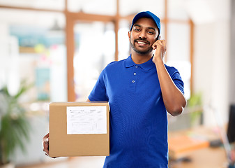 Image showing indian delivery man with smartphone and parcel box