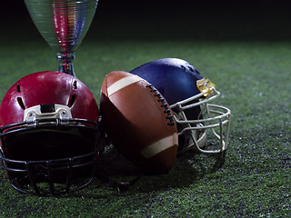 Image showing closeup of american football,helmets and trophy