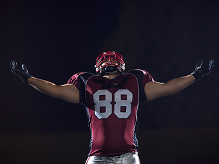 Image showing american football player celebrating after scoring a touchdown