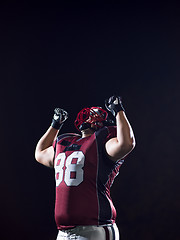 Image showing american football player celebrating after scoring a touchdown