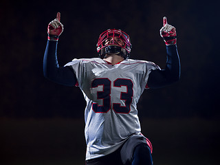 Image showing american football player celebrating after scoring a touchdown